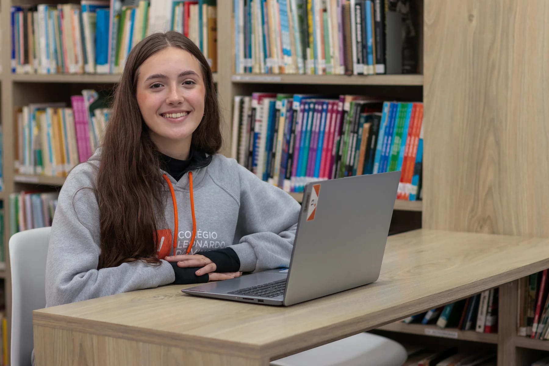 Estudante usando um notebook na biblioteca do Colégio Leonardo da Vinci